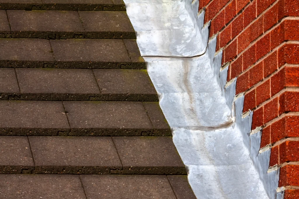 step flashing against a brick chimney