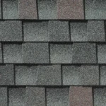 Close-up view of gray asphalt roof shingles with a rough, textured surface, arranged in an overlapping horizontal pattern—ideal for quality roofing Tampa homeowners trust.