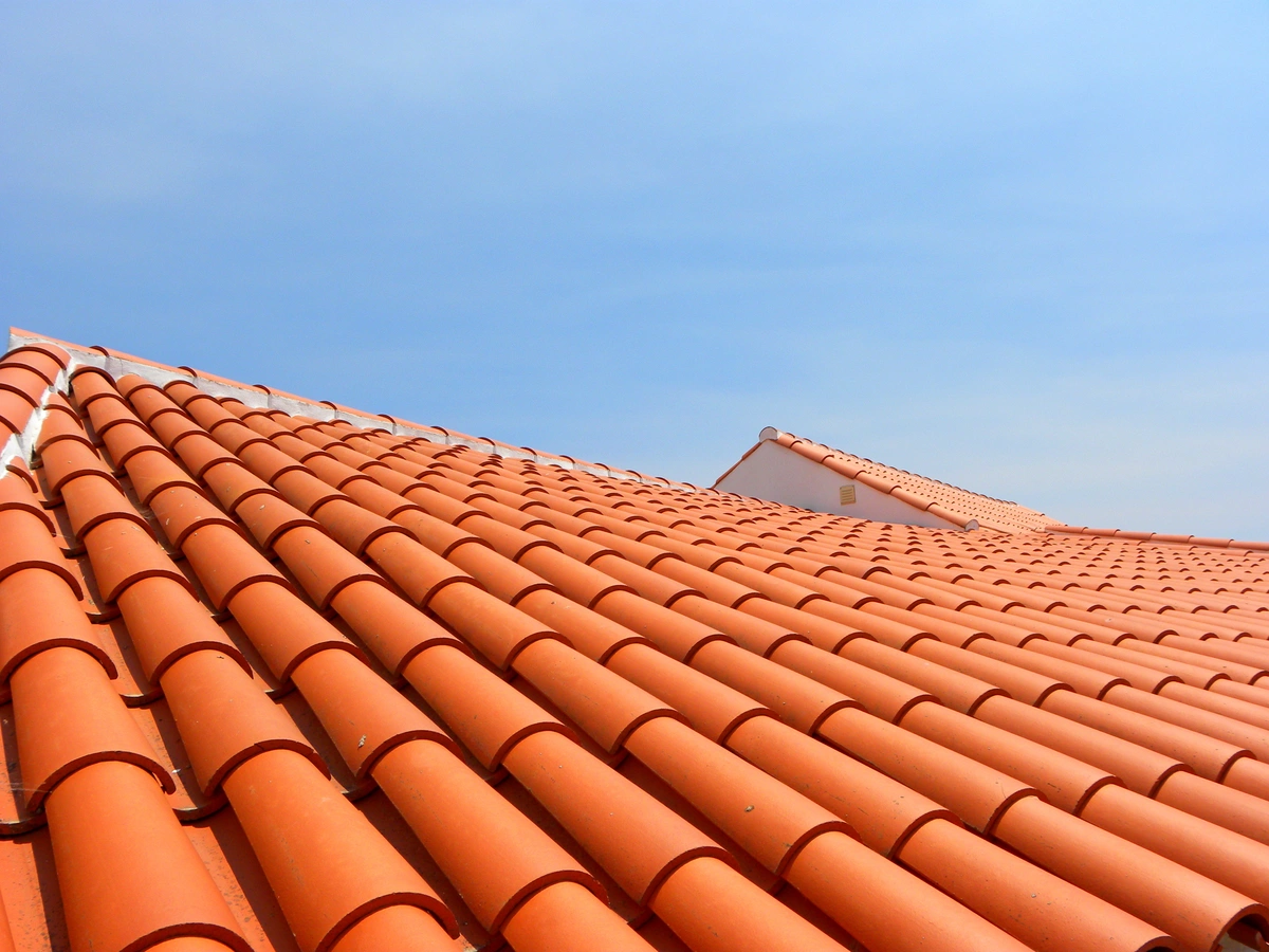 metal roof vs tile roof in florida: replaced tile roof of a large house 
