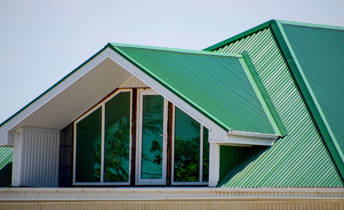 modern house with green corrugated metal roof