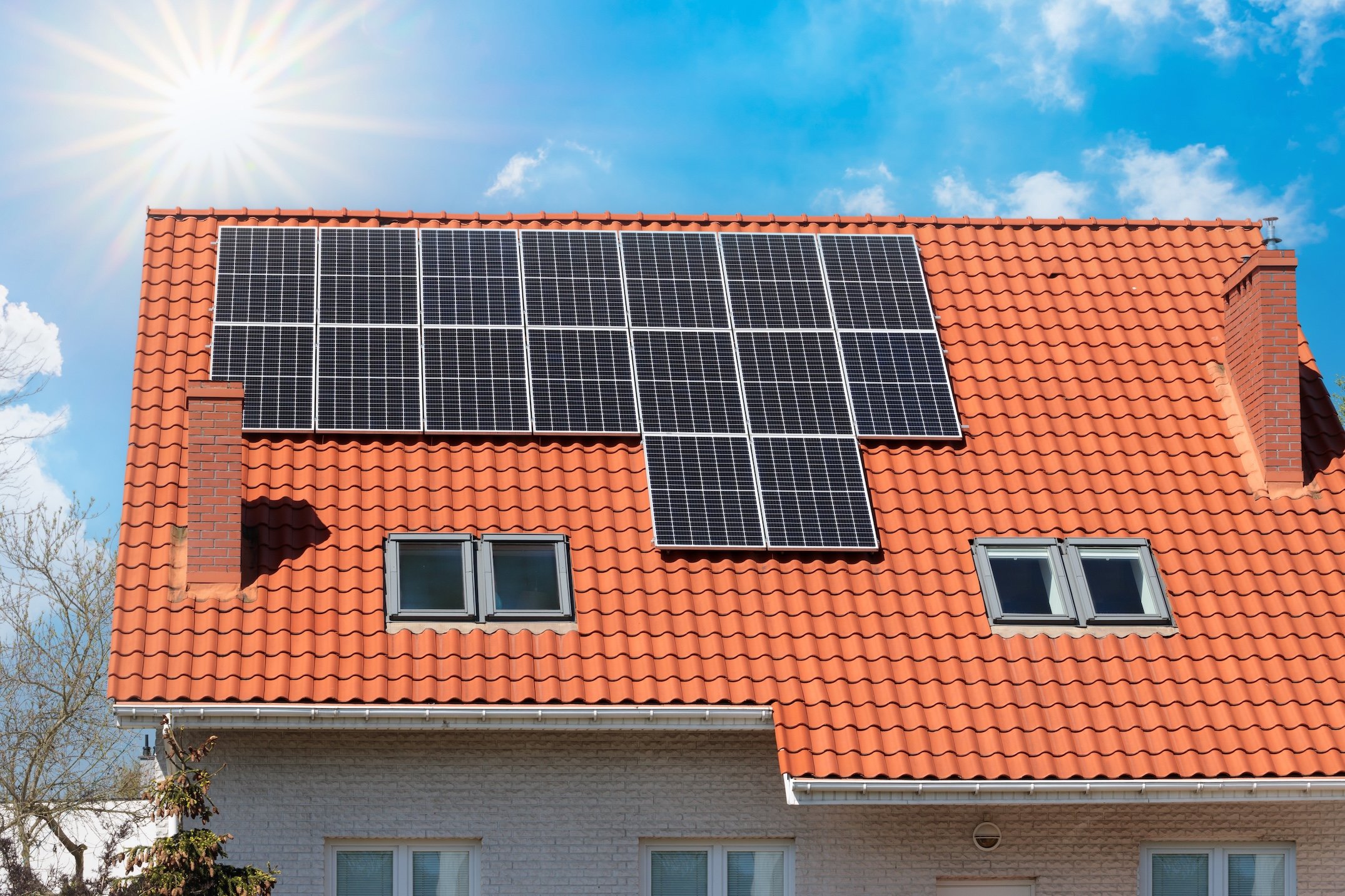 Solar panel array on the roof of a contemporary house.