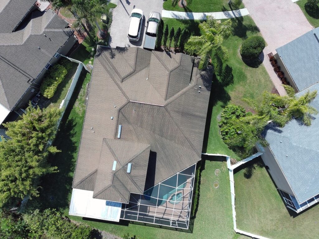 drone roof inspection house in neighbourhood cenital view summer time